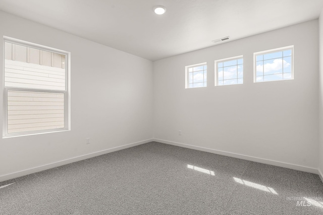 unfurnished room with carpet floors and baseboards