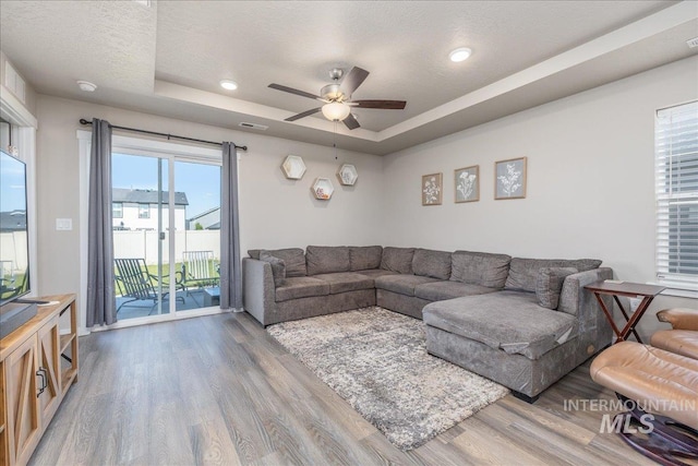 17719 Jackson Ridge Way, Nampa, ID 83687 - living room with wood finished floors, a raised ceiling, and a ceiling fan