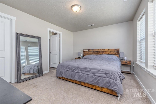17719 Jackson Ridge Way, Nampa, ID 83687 - bedroom featuring carpet floors, multiple windows, a textured ceiling, and baseboards
