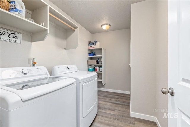 17719 Jackson Ridge Way, Nampa, ID 83687 - laundry area featuring separate washer and dryer, baseboards, wood finished floors, and a textured ceiling