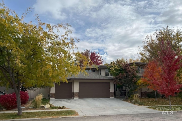 view of property hidden behind natural elements featuring a garage