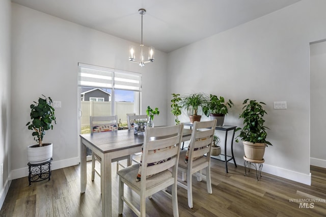 dining area with baseboards, a chandelier, and wood finished floors
