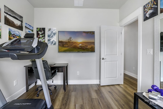 office space with visible vents, baseboards, and wood finished floors