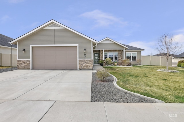 view of front of home with a front yard, fence, a garage, and concrete driveway