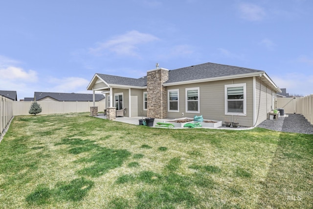 rear view of property featuring a yard, a fenced backyard, a patio, and roof with shingles