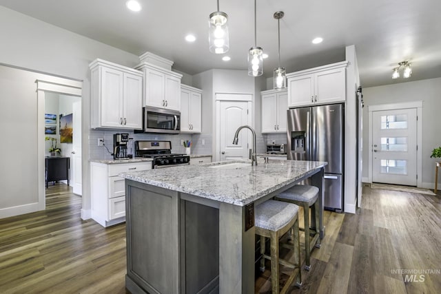 kitchen with a sink, white cabinets, and stainless steel appliances