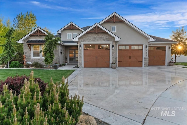 craftsman house with stone siding, concrete driveway, an attached garage, a front yard, and stucco siding