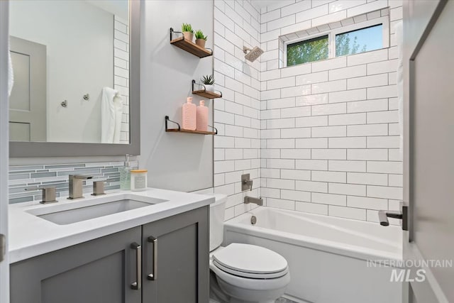 full bath featuring toilet, decorative backsplash,  shower combination, and vanity