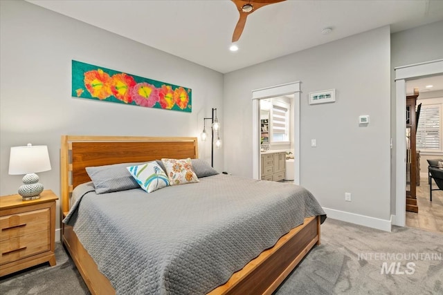 carpeted bedroom featuring recessed lighting, baseboards, ensuite bathroom, and ceiling fan