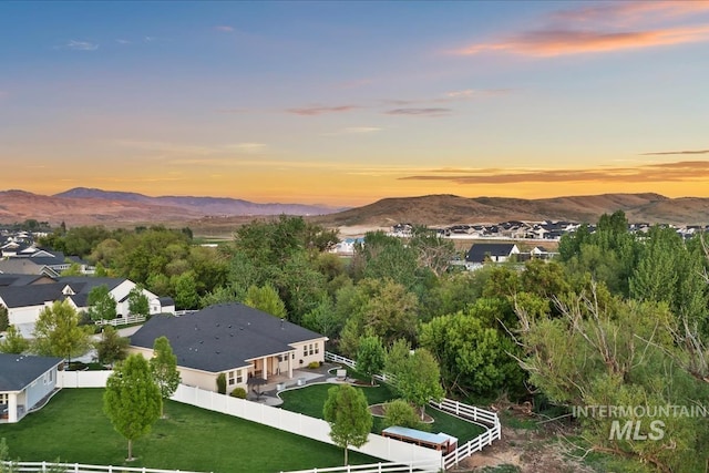 aerial view of property and surrounding area featuring a mountainous background