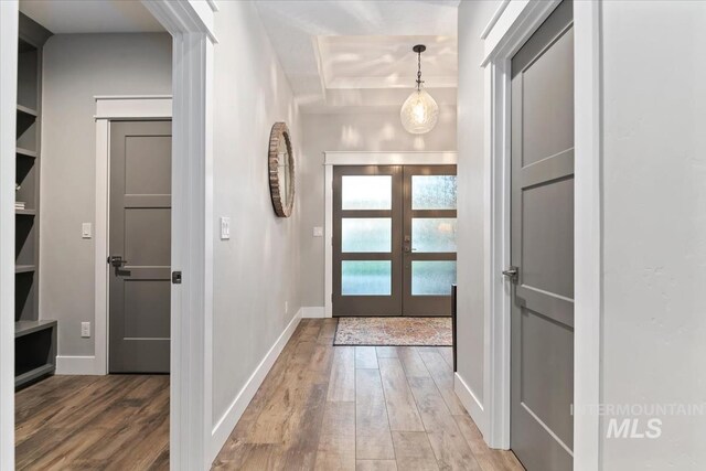 entryway featuring wood finished floors, french doors, and baseboards