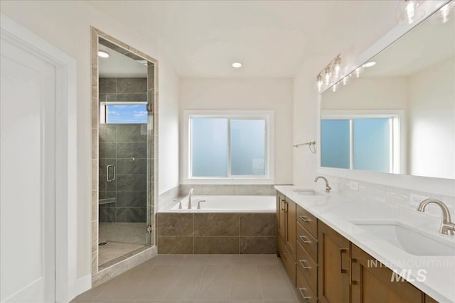 bathroom with independent shower and bath, tile patterned flooring, vanity, and a healthy amount of sunlight