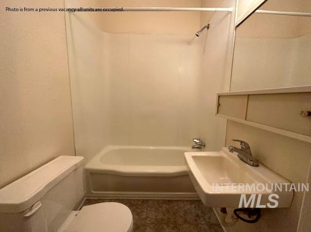 full bathroom featuring  shower combination, toilet, and sink