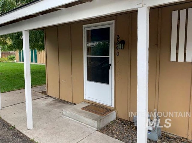 doorway to property with a yard