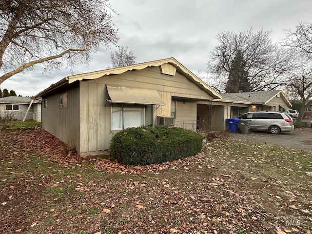 view of front of home featuring central AC and driveway