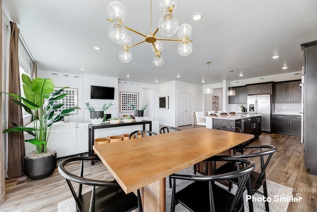 dining room with recessed lighting and light wood-type flooring
