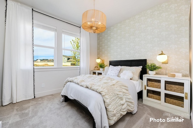 carpeted bedroom featuring wallpapered walls and baseboards