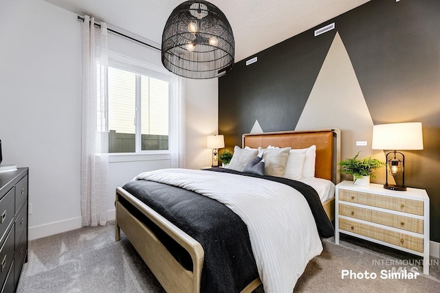 carpeted bedroom featuring baseboards