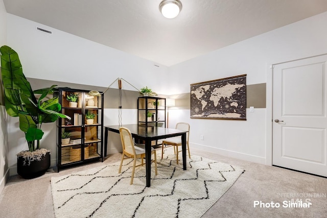 dining room featuring baseboards, visible vents, and carpet