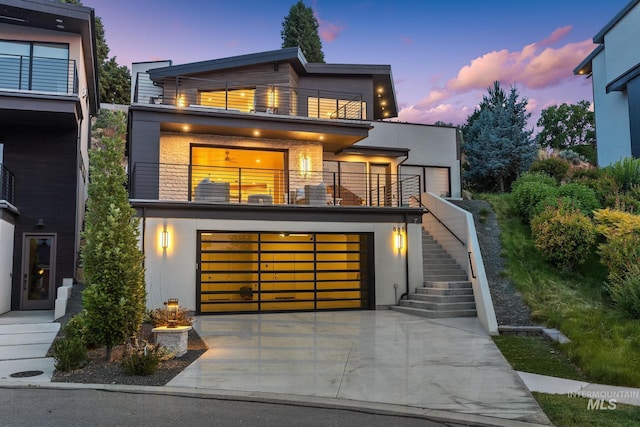 885 E Joplin Ln, Eagle, ID 83616 - contemporary home with a balcony, driveway, stucco siding, stairway, and an attached garage