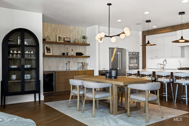 885 E Joplin Ln, Eagle, ID 83616 - dining area featuring beverage cooler, dark wood-style flooring, and recessed lighting