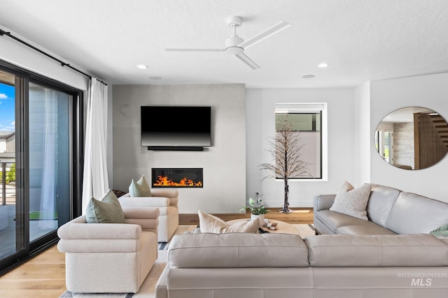 885 E Joplin Ln, Eagle, ID 83616 - living area featuring light wood-type flooring, a large fireplace, recessed lighting, and ceiling fan
