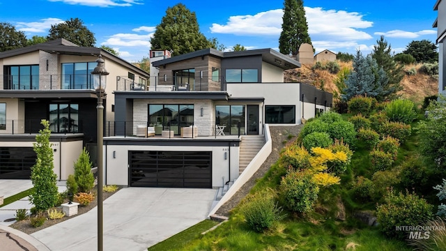 885 E Joplin Ln, Eagle, ID 83616 - modern home with stucco siding, concrete driveway, a garage, and a balcony