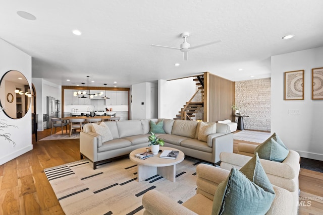 885 E Joplin Ln, Eagle, ID 83616 - living room featuring stairway, light wood-type flooring, recessed lighting, ceiling fan, and a chandelier