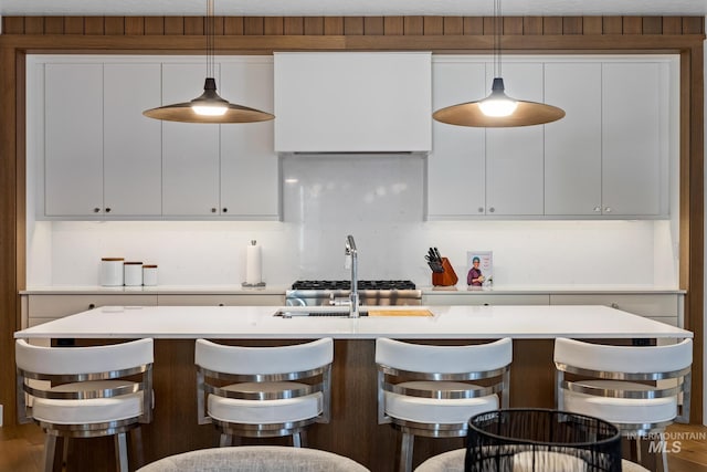 885 E Joplin Ln, Eagle, ID 83616 - kitchen with white cabinetry, light countertops, and decorative light fixtures