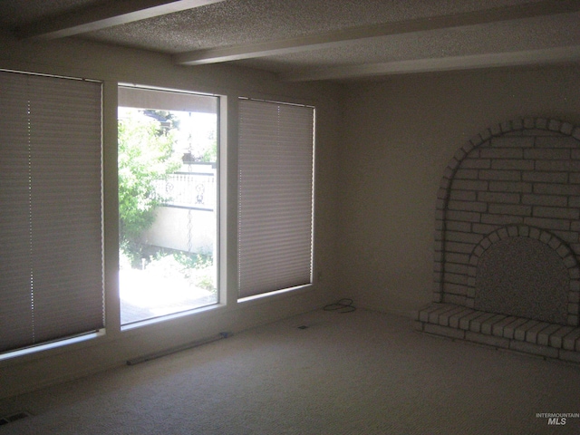 11254 W Camas St, Boise, ID 83709 - unfurnished living room featuring plenty of natural light, beamed ceiling, carpet flooring, and a textured ceiling