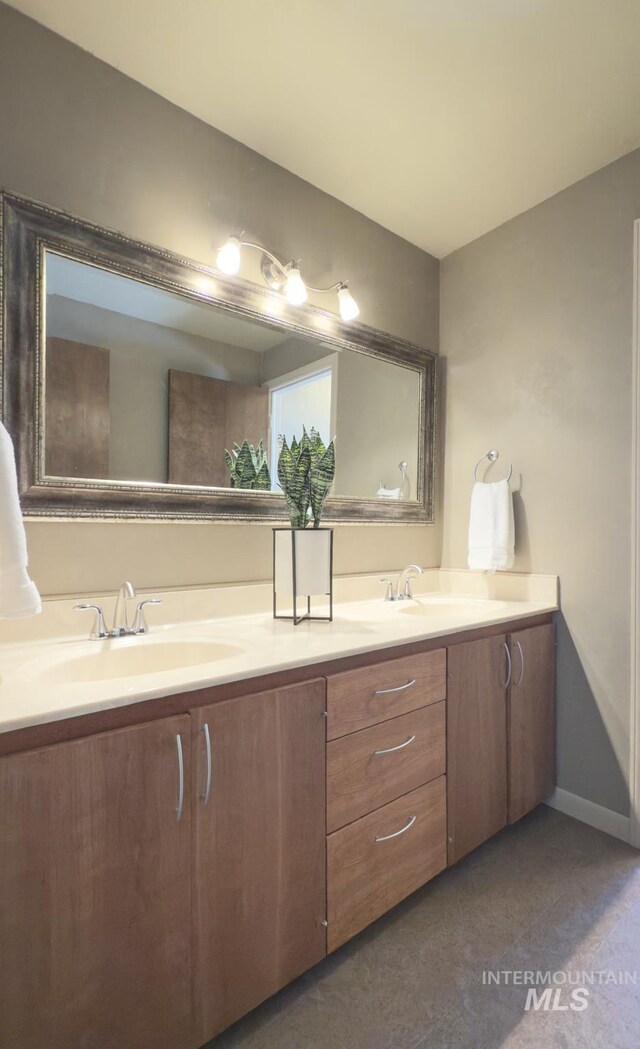 11254 W Camas St, Boise, ID 83709 - bathroom featuring double vanity and baseboards