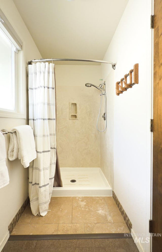 11254 W Camas St, Boise, ID 83709 - bathroom featuring tile patterned floors, a shower with curtain, and baseboards