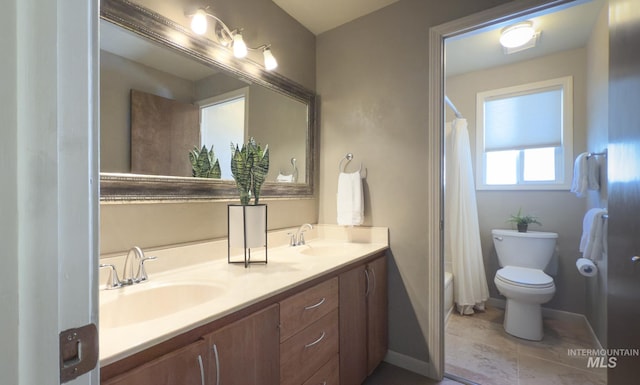 11254 W Camas St, Boise, ID 83709 - full bathroom with double vanity, toilet, shower / bath combo, and baseboards