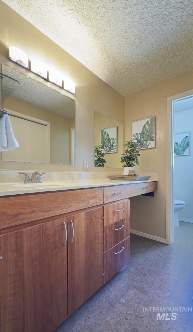 11254 W Camas St, Boise, ID 83709 - full bath featuring double vanity, toilet, baseboards, and a textured ceiling