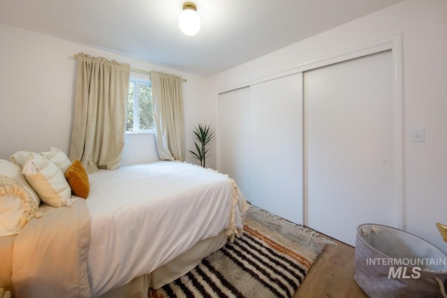 bedroom with a closet and wood finished floors