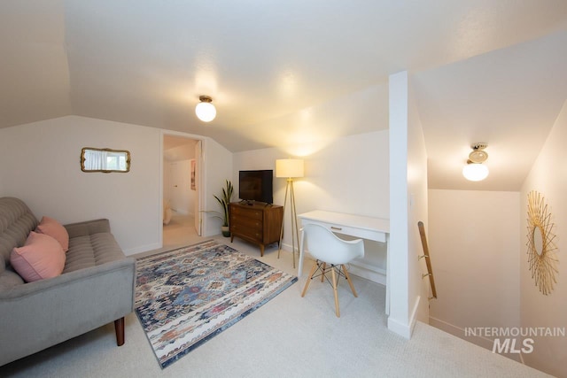 living area featuring lofted ceiling, baseboards, and light colored carpet