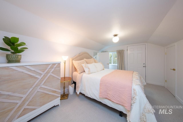 bedroom featuring carpet floors and lofted ceiling