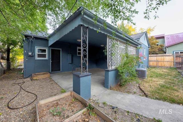 exterior space with central air condition unit and fence