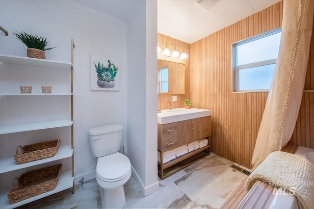 full bath with visible vents, vanity, toilet, and baseboards