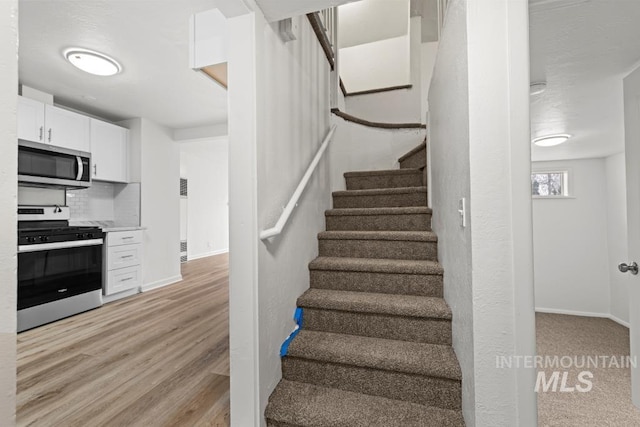 staircase with wood-type flooring