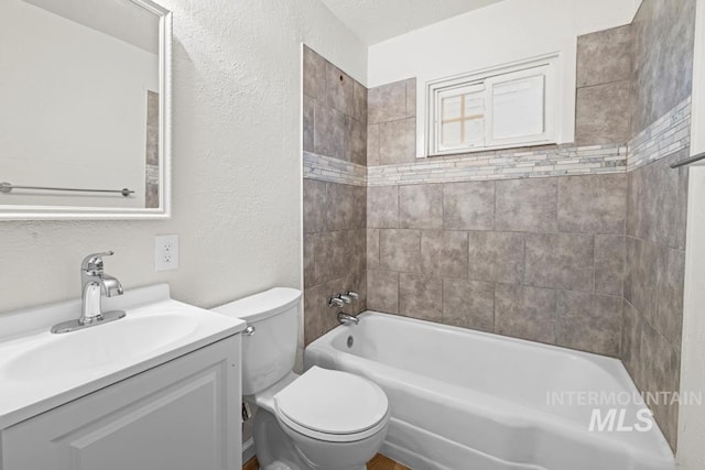 full bathroom featuring toilet, vanity, and tiled shower / bath