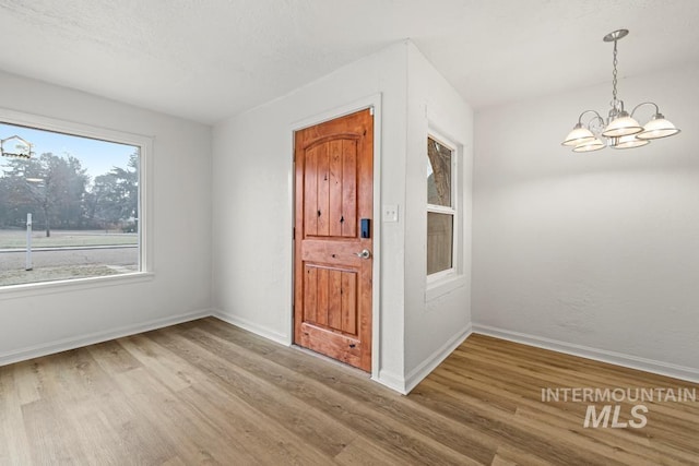 entryway featuring a notable chandelier and hardwood / wood-style floors