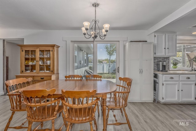 dining space featuring a notable chandelier and light wood finished floors