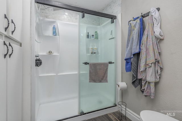 full bathroom with toilet and a shower stall