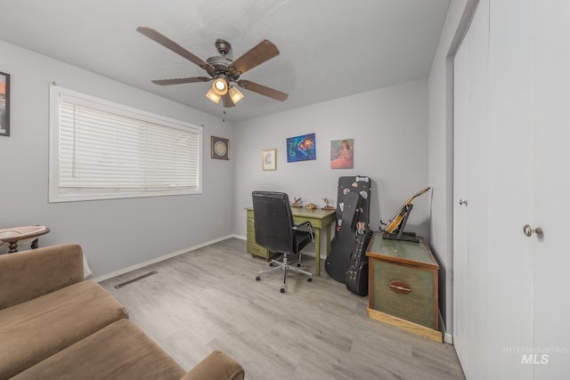 office space featuring baseboards, wood finished floors, and a ceiling fan