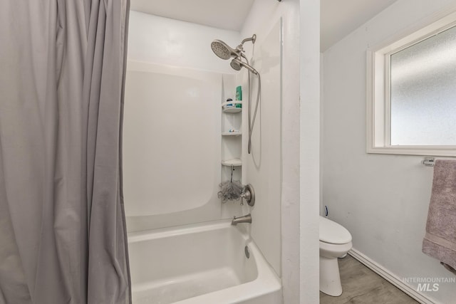 full bath with toilet, shower / bath combo with shower curtain, and wood finished floors