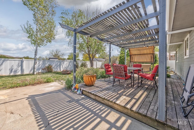 view of patio / terrace with outdoor dining area, a pergola, a wooden deck, and a fenced backyard