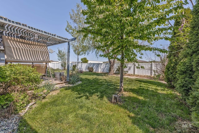view of yard featuring a pergola and a fenced backyard