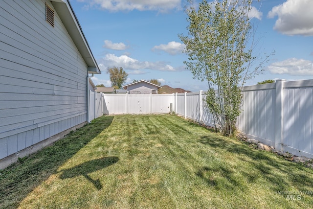 view of yard with a fenced backyard