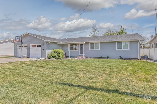 ranch-style home featuring a front lawn, driveway, an attached garage, and fence